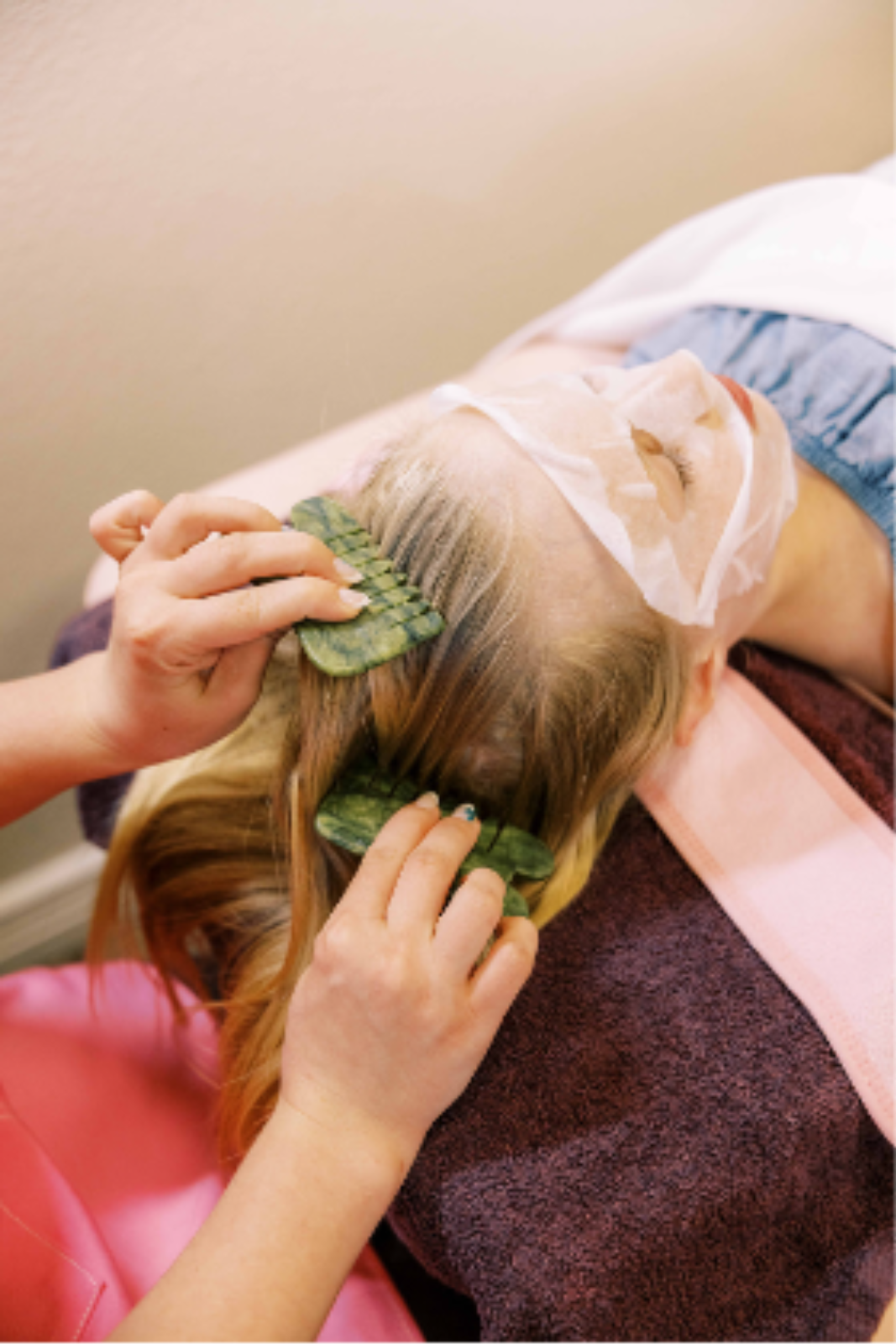 Facial treatment products displayed with green leaves for a natural spa aesthetic