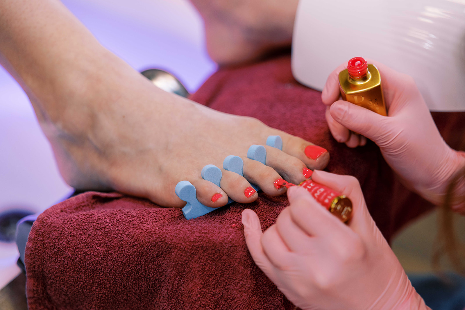 Clean, natural nails after a pedicure with a wooden bowl beside them