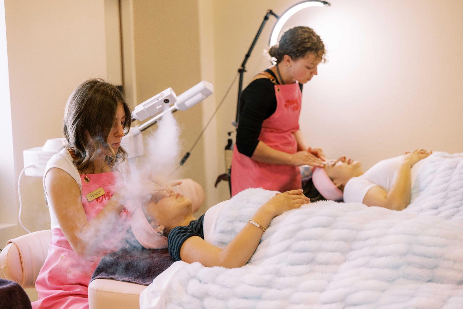 Mother and daughter wrapped in soft white towels enjoying a spa day together