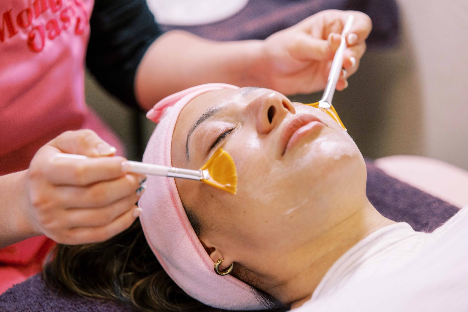 Woman receiving a luxury facial treatment in a serene spa setting